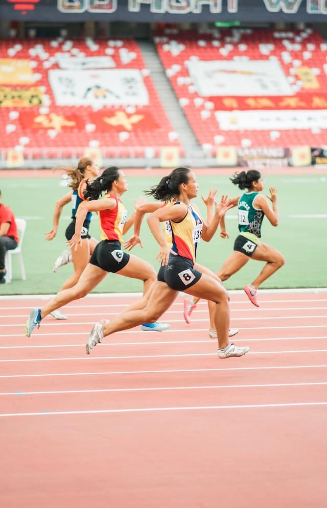 A group of runners on a track in a stadium